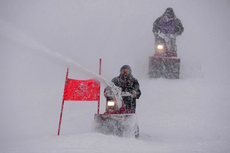 Skiers struggle as real snow falls on Winter Olympics